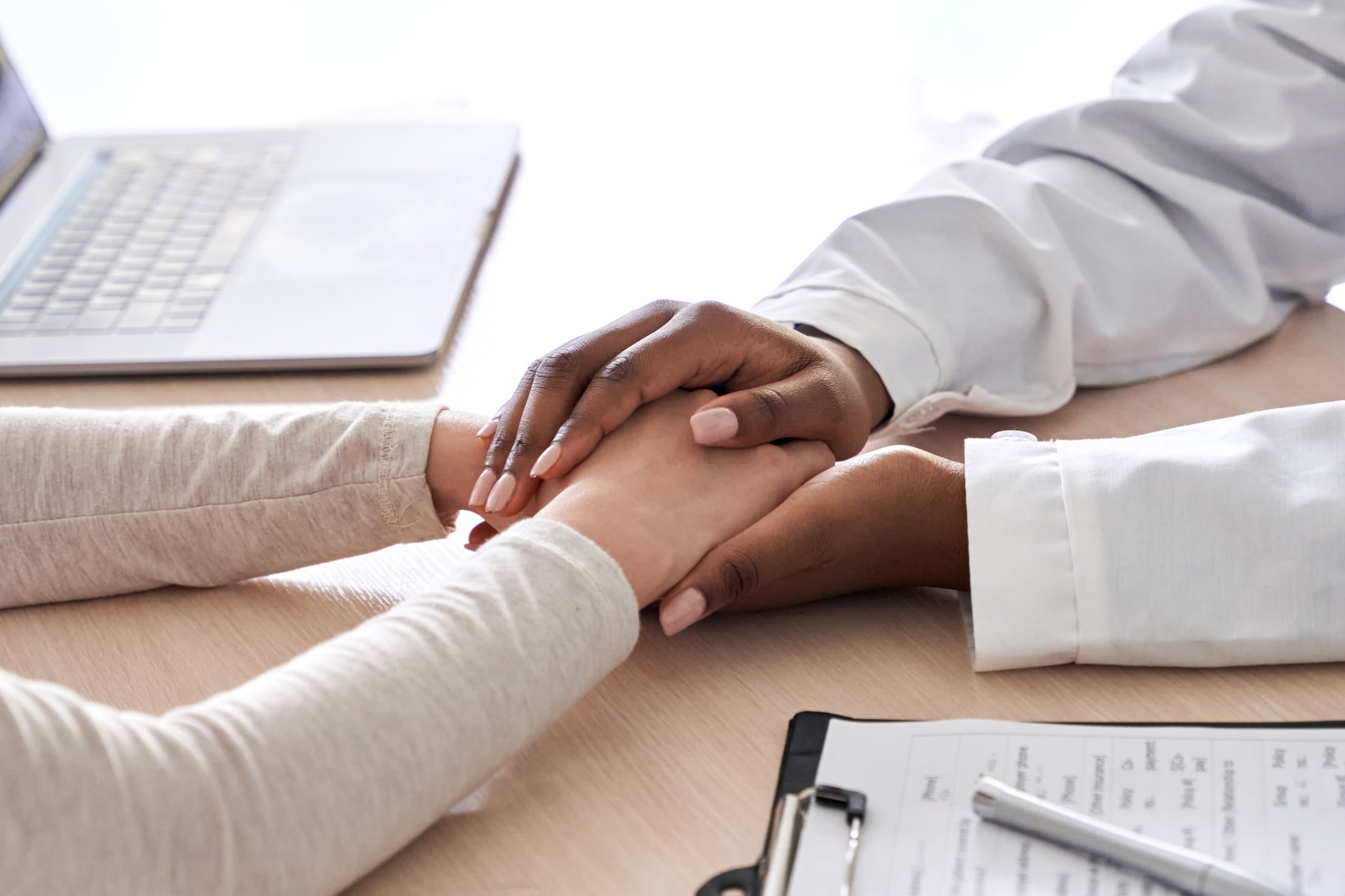 Doctor Holding Hands of Patient to Show Support